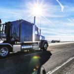 Expressway Flatbed Semi Trailer Trucks On Western USA Sunflare Highway